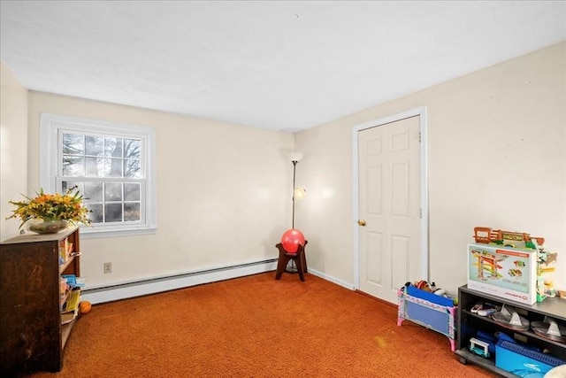 recreation room with carpet and a baseboard heating unit