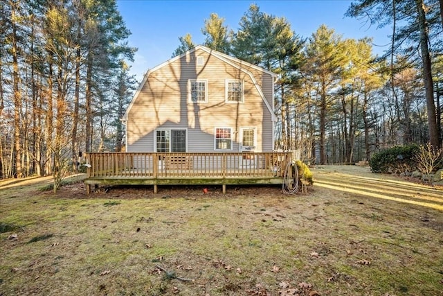 back of house featuring a yard and a deck