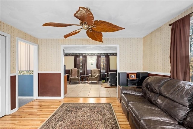 living room with ceiling fan and light wood-type flooring