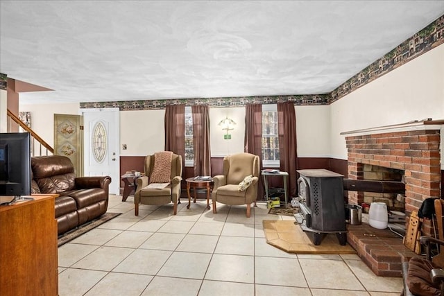 tiled living room featuring a wood stove