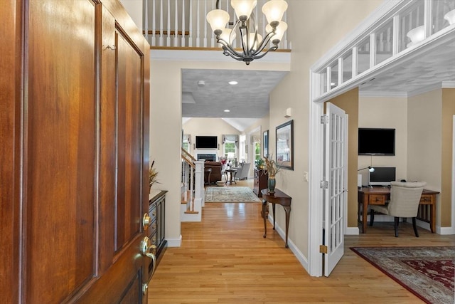 89 Cortland Dr Unit 89, North Andover, MA 01845 - foyer entrance featuring light wood-type flooring, baseboards, a chandelier, and vaulted ceiling