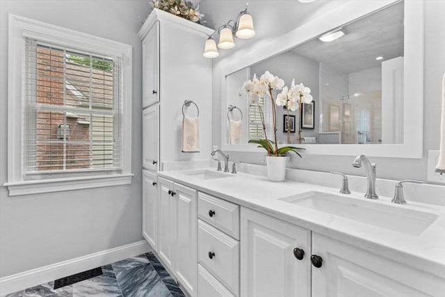 89 Cortland Dr Unit 89, North Andover, MA 01845 - bathroom featuring double vanity, a shower stall, marble look tiles, and baseboards