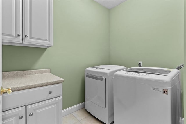 89 Cortland Dr Unit 89, North Andover, MA 01845 - laundry room featuring cabinet space, washing machine and dryer, baseboards, and light tile patterned flooring