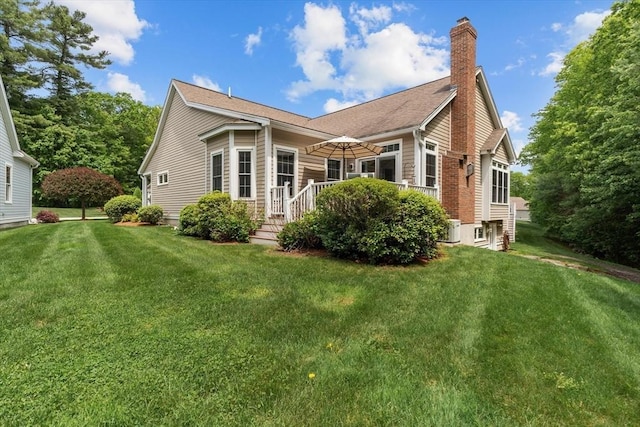 89 Cortland Dr Unit 89, North Andover, MA 01845 - rear view of house featuring a chimney and a lawn