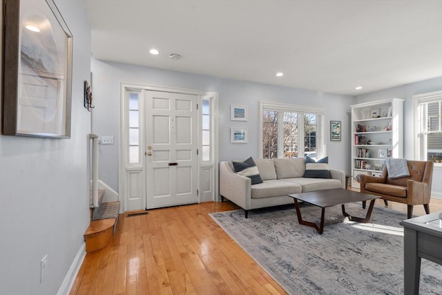 living room with plenty of natural light and light hardwood / wood-style flooring