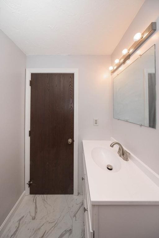 bathroom featuring vanity and marble finish floor