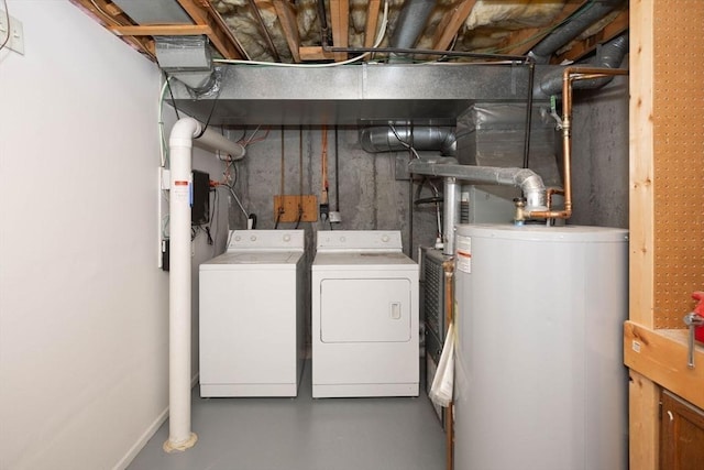 washroom with gas water heater, washing machine and dryer, and laundry area