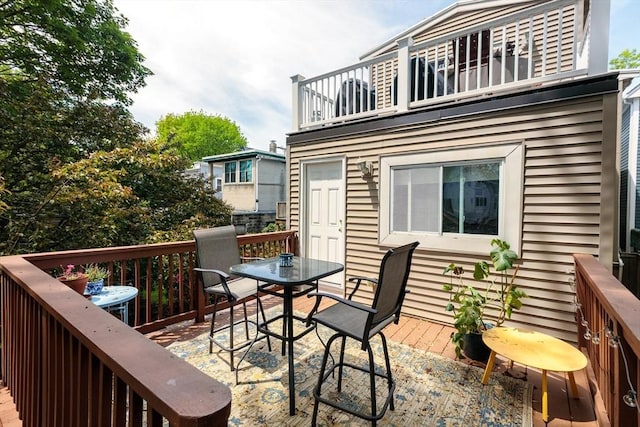 wooden terrace featuring outdoor dining area