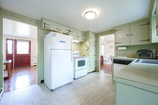 kitchen featuring white appliances, a baseboard radiator, light countertops, and a sink