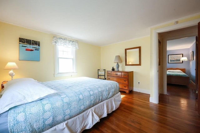 bedroom featuring dark wood-type flooring, baseboards, and ornamental molding
