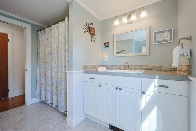 bathroom with ornamental molding, vanity, tile patterned flooring, and baseboards
