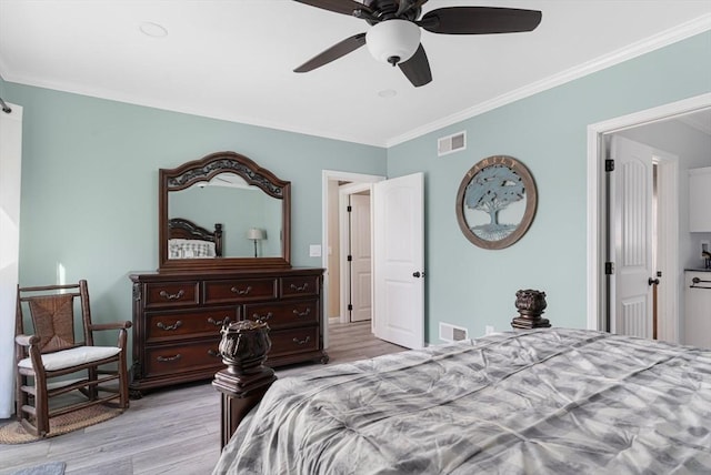 bedroom featuring visible vents, ornamental molding, ceiling fan, and wood finished floors