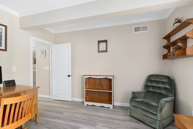 sitting room with visible vents, baseboards, wood finished floors, and crown molding