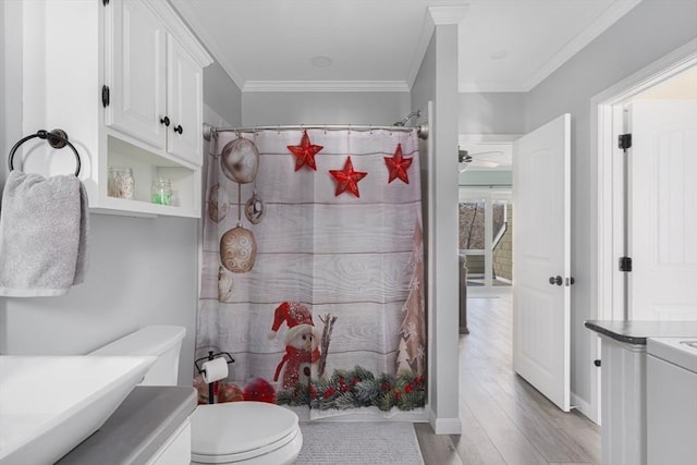 bathroom with crown molding, toilet, a shower with shower curtain, wood finished floors, and vanity