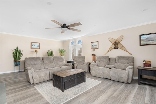 living area with light wood-style flooring, ornamental molding, baseboards, and ceiling fan