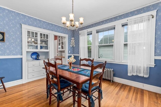 86 Glencoe St Unit 86, Boston, MA 02135 - dining space with radiator heating unit, wallpapered walls, a chandelier, light wood-style floors, and baseboards