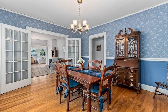 86 Glencoe St Unit 86, Boston, MA 02135 - dining space with wood finished floors, a chandelier, wallpapered walls, and crown molding