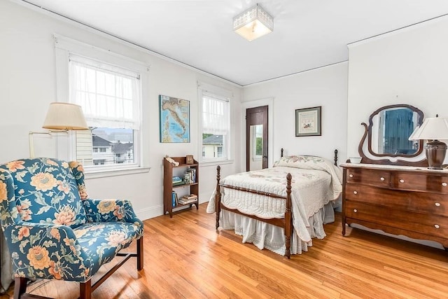 86 Glencoe St Unit 86, Boston, MA 02135 - bedroom featuring multiple windows, light wood-style floors, baseboards, and ornamental molding