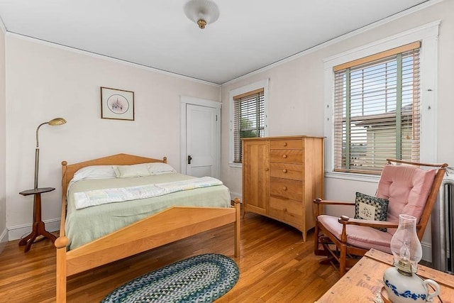86 Glencoe St Unit 86, Boston, MA 02135 - bedroom with wood finished floors, crown molding, and baseboards