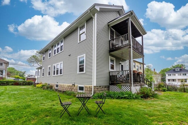 86 Glencoe St Unit 86, Boston, MA 02135 - rear view of property with a balcony and a lawn