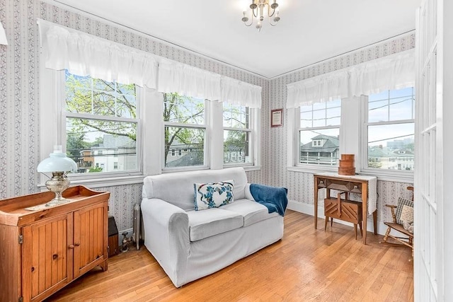 86 Glencoe St Unit 86, Boston, MA 02135 - sitting room featuring wallpapered walls, light wood-type flooring, plenty of natural light, baseboards, and a chandelier