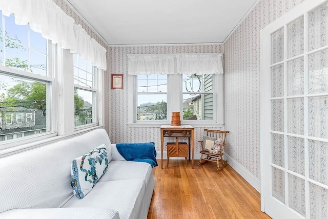 86 Glencoe St Unit 86, Boston, MA 02135 - living area featuring wallpapered walls, light wood finished floors, ornamental molding, and baseboards