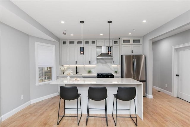 755 Boylston St Unit 1, Brookline, MA 02467 - kitchen with freestanding refrigerator, wall chimney exhaust hood, light countertops, baseboards, and recessed lighting