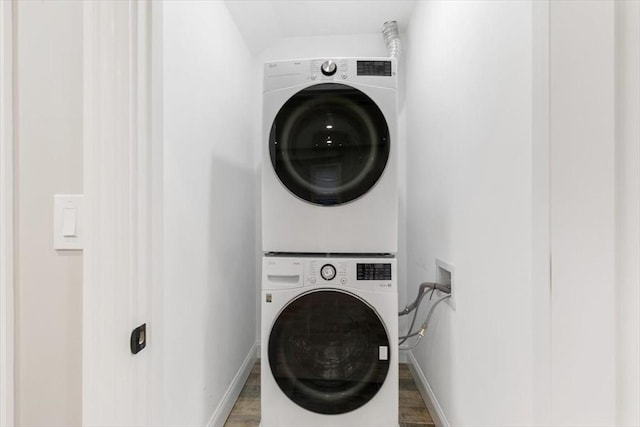 755 Boylston St Unit 1, Brookline, MA 02467 - laundry area with estacked washer and dryer, wood finished floors, and baseboards