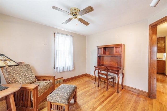 sitting room featuring visible vents, light wood finished floors, baseboards, and ceiling fan