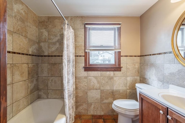 full bath with toilet, vanity, shower / bath combo with shower curtain, and tile walls