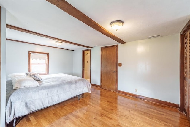 bedroom with baseboards, visible vents, and light wood-style floors