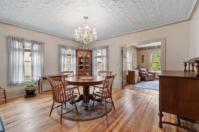 98 Mechanic St, Orange, MA 01364 - dining space with ornamental molding, an ornate ceiling, light wood finished floors, and a chandelier