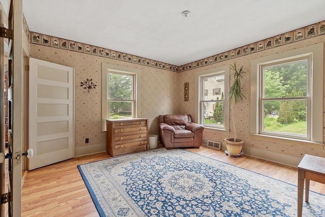 98 Mechanic St, Orange, MA 01364 - living area with light wood-type flooring, plenty of natural light, and wallpapered walls