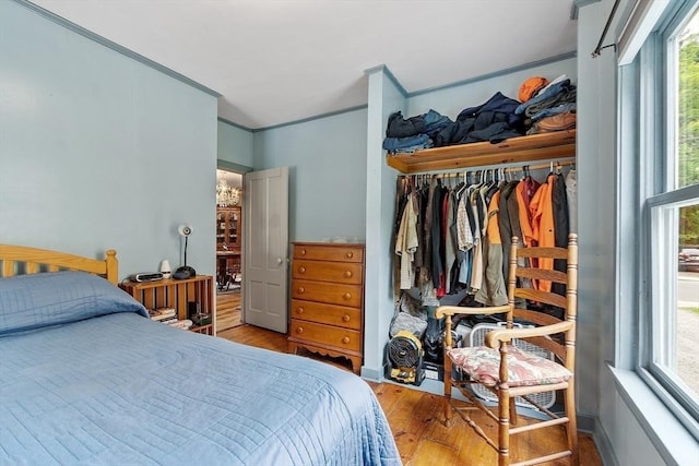 98 Mechanic St, Orange, MA 01364 - bedroom with wood finished floors, multiple windows, a closet, and ornamental molding