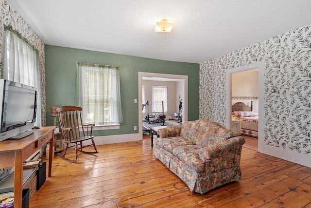 98 Mechanic St, Orange, MA 01364 - living room with wallpapered walls, light wood finished floors, and an accent wall