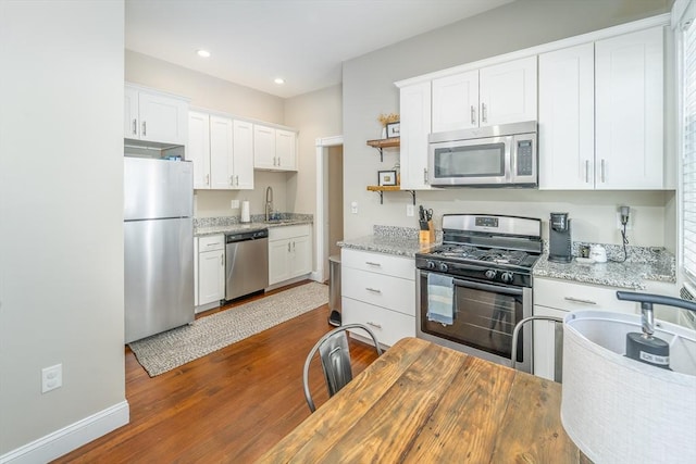 646 E 7th St Unit 1, Boston, MA 02127 - kitchen with appliances with stainless steel finishes, white cabinetry, open shelves, dark wood-style floors, and recessed lighting