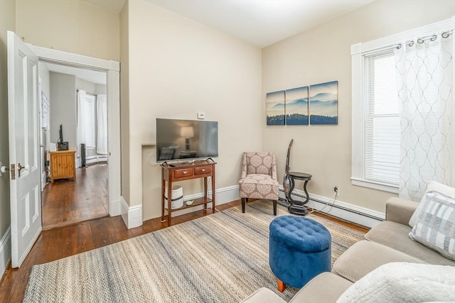 646 E 7th St Unit 1, Boston, MA 02127 - living area featuring baseboard heating, wood finished floors, and healthy amount of natural light