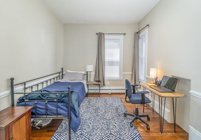 646 E 7th St Unit 1, Boston, MA 02127 - bedroom featuring wood finished floors, a desk, and a baseboard radiator