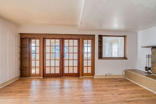 entryway featuring french doors and light wood-type flooring