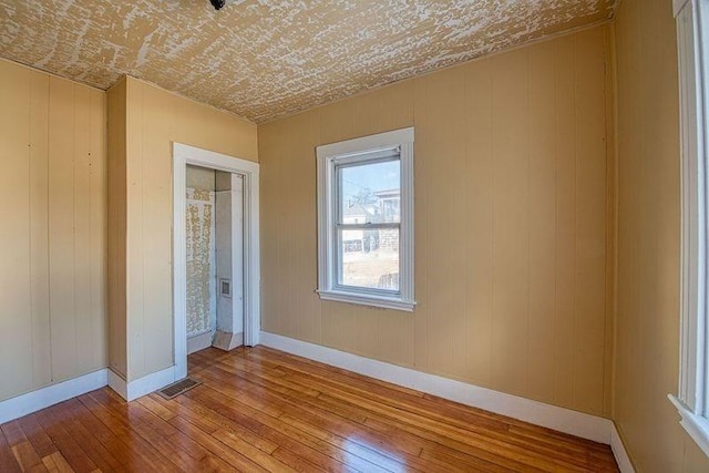 spare room featuring wood-type flooring