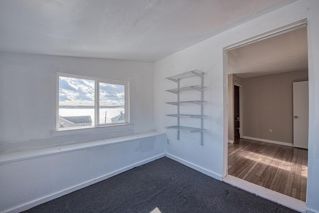 spare room featuring dark wood-type flooring