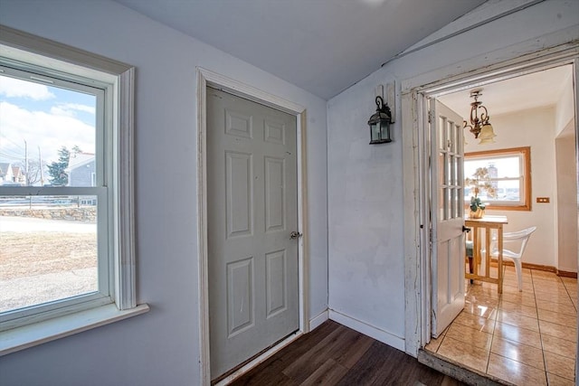 interior space featuring hardwood / wood-style flooring, lofted ceiling, and a notable chandelier