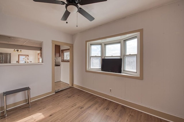 unfurnished room featuring ceiling fan and light wood-type flooring