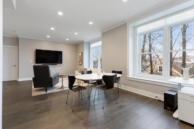 dining room with dark wood finished floors, baseboards, and ornamental molding