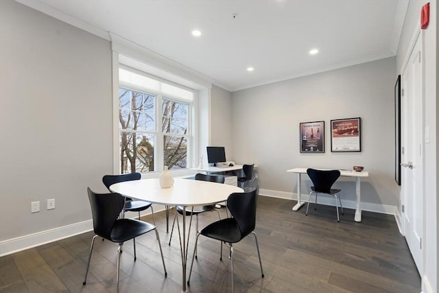 dining space featuring baseboards, dark wood finished floors, and crown molding