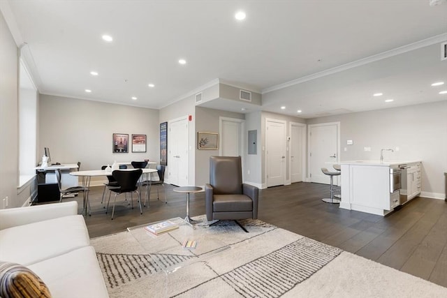 living area with dark wood finished floors, visible vents, recessed lighting, and ornamental molding