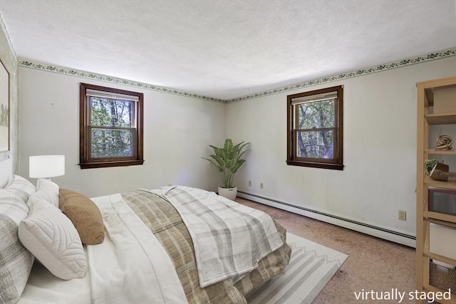 62 Brook St, Wakefield, MA 01880 - bedroom with a baseboard heating unit, carpet flooring, and a textured ceiling