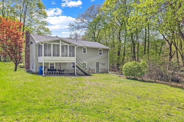 62 Brook St, Wakefield, MA 01880 - rear view of property with a sunroom, stairway, a chimney, and a lawn