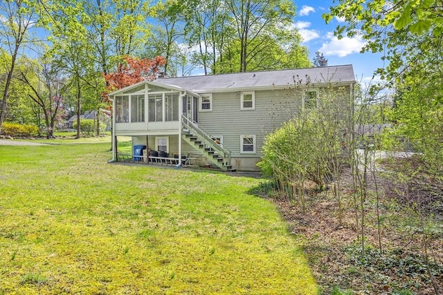 62 Brook St, Wakefield, MA 01880 - back of house featuring a sunroom, stairs, and a yard