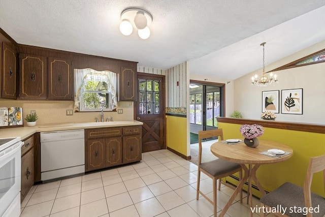 62 Brook St, Wakefield, MA 01880 - kitchen with white appliances, light countertops, baseboard heating, dark brown cabinets, and lofted ceiling